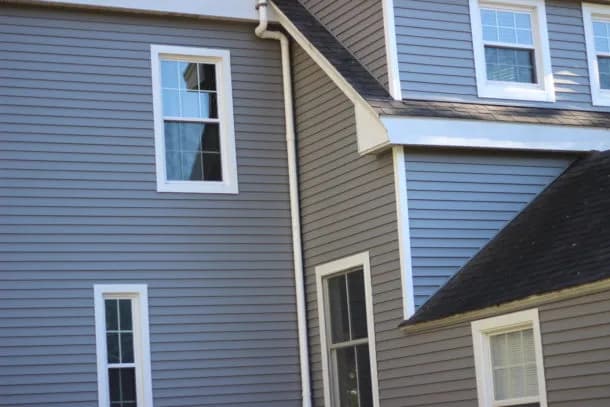 Cedar shingle siding covering the exterior of a North Deering farmhouse