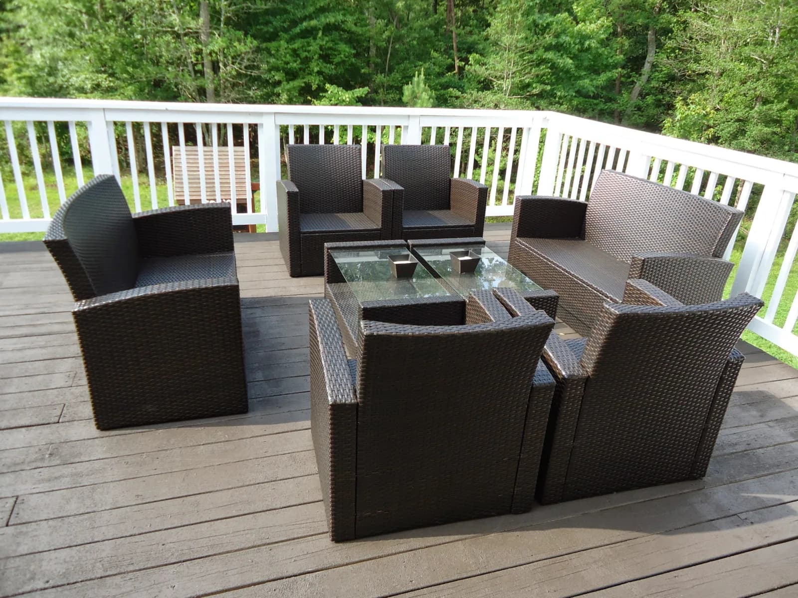 Composite deck furnished as an outdoor living space backing onto woods